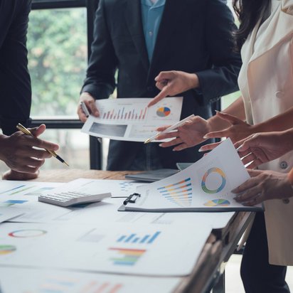 Personen analysieren gemeinsam Diagramme und Kennzahlen zur Bewertung der Energieeffizienz in einem Unternehmen.