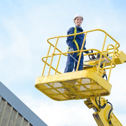 Arbeiter in Sicherheitskleidung auf einer Hebebühne während einer Schulung.