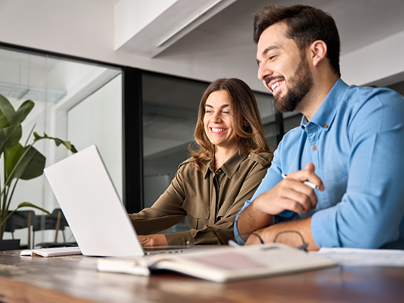 Zwei Mitarbeiten schauen sich Änderungen im Laptop an 