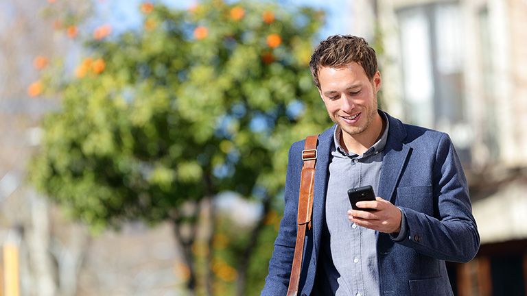 Young urban professional man using smart phone