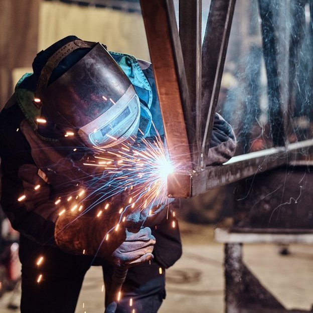 workers with protective equipment during manual welding