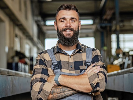 Facharbeiter in Latzhose als Symbol für Weiterbildungen durch das Technische Schulungszentrum des TÜV NORD.