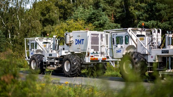 Darstellung einer Geothermie-Anlage, die die Nutzung von Erdwärme zur Energiegewinnung zeigt, mit Bohrgeräten und technischen Einrichtungen im Vordergrund.