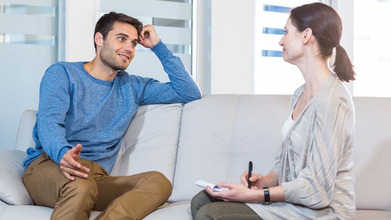 Psychologist talking with happy man