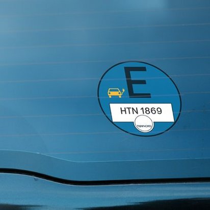TÜV NORD E-Plakette Produktbild einer blauen e-Plakette auf der Scheibe eines Autos