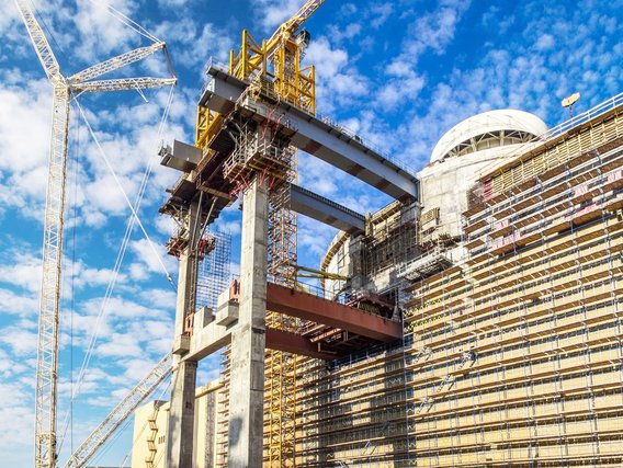 Reaktorbaustelle mit Betonstruktur, Gerüsten und Krananlagen