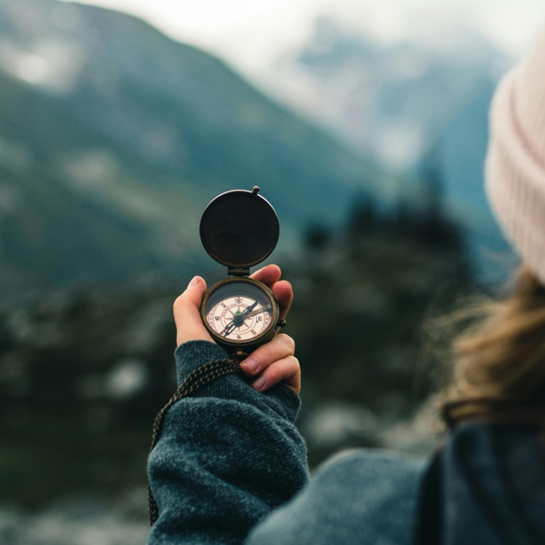 Woman checks the compass while hiking