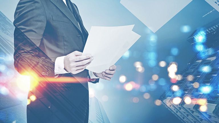 Businessman with papers, night cityscape Businessman with papers, night cityscape