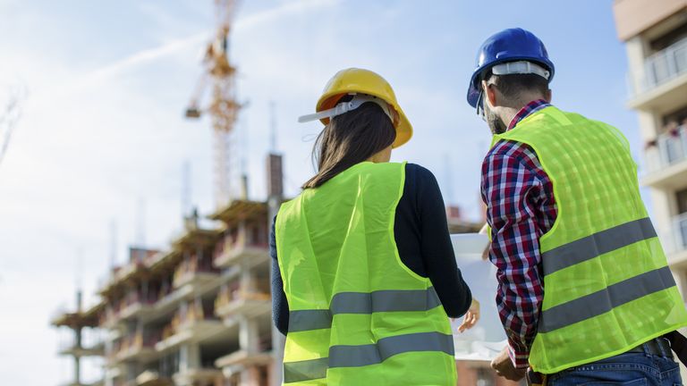 Construction worker and his manager checking the progress